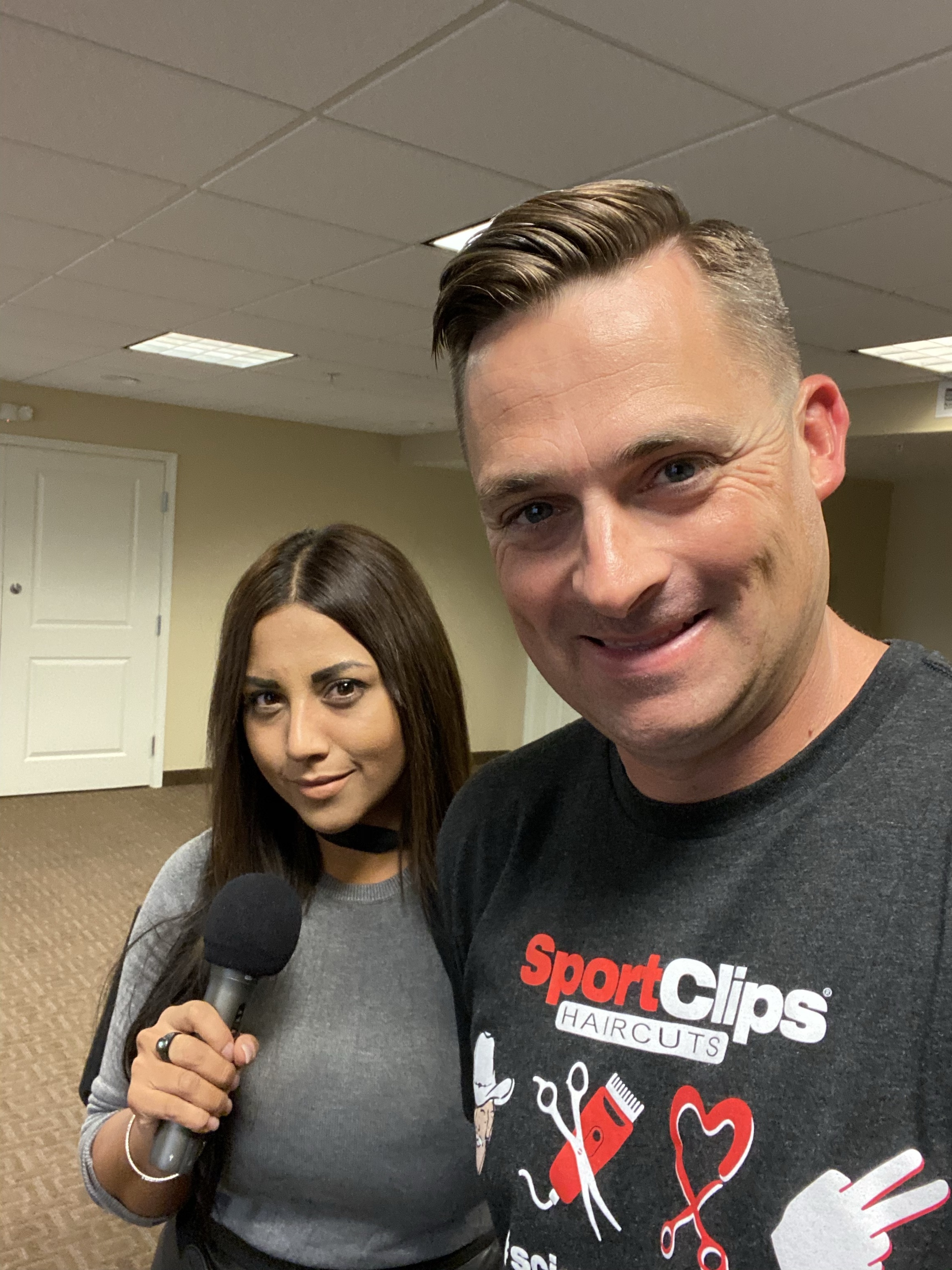 Chad Jordan and Jen Richard holding a microphone
